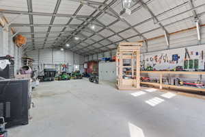 Garage featuring a garage door opener and a workshop area