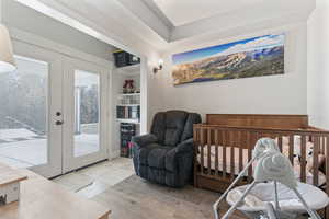 Bedroom featuring french doors, access to outside, and light wood-type flooring