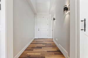 Hallway with dark wood-type flooring