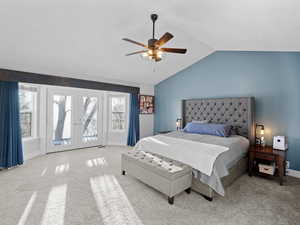 Carpeted bedroom featuring vaulted ceiling, access to exterior, ceiling fan, and french doors