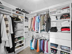 Walk in closet featuring carpet flooring