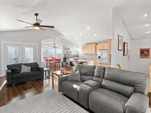 Living room featuring french doors, ceiling fan, dark hardwood / wood-style floors, and vaulted ceiling