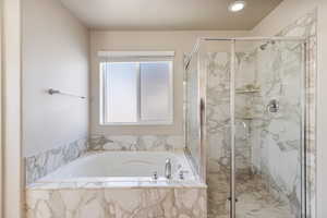 Ensuite Bathroom featuring separate shower and tub