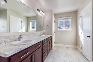 The ensuite bathroom features a double vanity, a soaking tub, an enclosed shower, and a huge walk-in closet