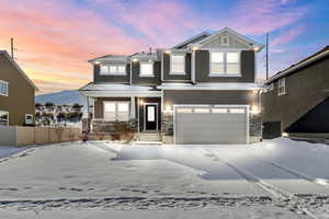 View of front of house with a mountain view and a garage