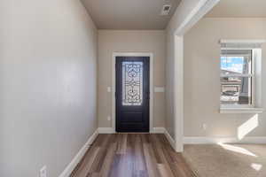 Entrance foyer featuring hardwood / wood-style floors