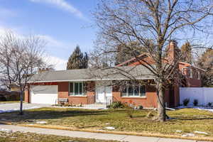 View of front of home with a garage and a front yard