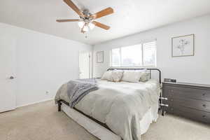 Bedroom featuring ceiling fan and light carpet