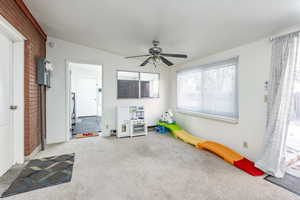 Playroom with light colored carpet and ceiling fan