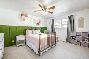 Bedroom featuring light carpet and ceiling fan