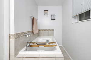 Bathroom featuring a relaxing tiled tub