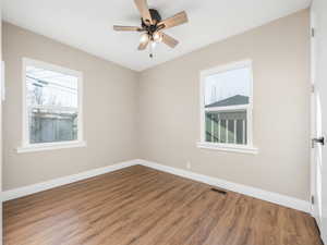 Spare room featuring ceiling fan and hardwood / wood-style floors