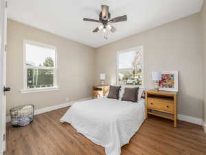 Bedroom with dark wood-type flooring and ceiling fan