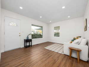 Entryway featuring dark wood flooring