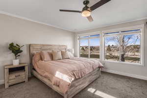 Bedroom featuring ornamental molding, carpet floors, and ceiling fan