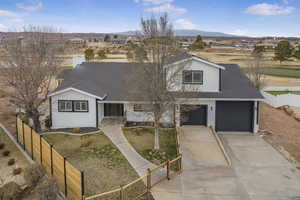 View of front facade with a mountain view and a garage