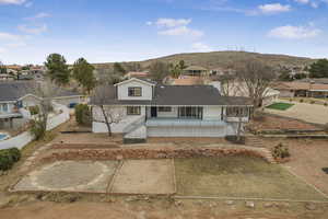 View of front of home featuring a mountain view and a porch