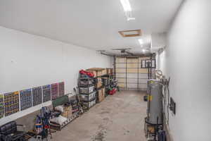 Garage with water heater and a garage door opener