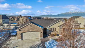 View of front facade with a garage and a lake and mountain view