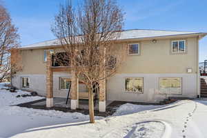 View of snow covered back of property