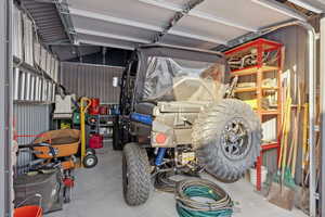 View of snow covered accessory garage for storage and toys