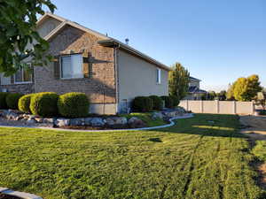 Summer/Spring View of front of house with a garage and a front lawn