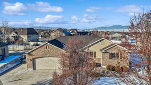 Exterior space featuring a garage and a lake and mountain view