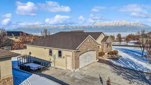 View of front of house with a garage and a lake and mountain view