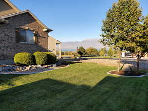 Summer/Spring View of yard featuring a lake and mountain view