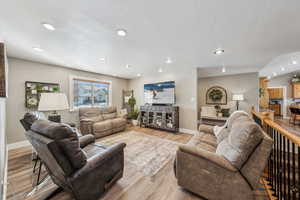 Living room with light hardwood / wood-style flooring
