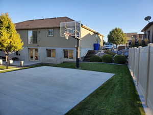 View of sport court featuring a lawn