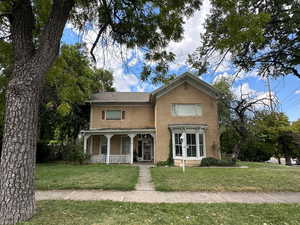 View of front of home featuring a front lawn and french doors