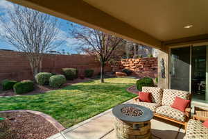 View of yard featuring an outdoor fire pit and a patio area