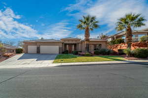 View of front of house featuring a garage and a front yard