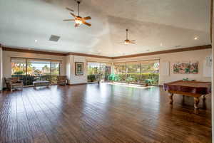 Interior space with vaulted ceiling, pool table, and hardwood / wood-style floors