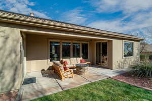 View of patio with an outdoor living space with a fire pit