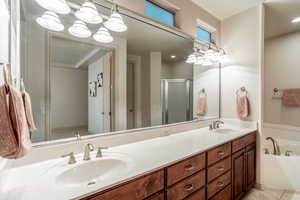 Bathroom with vanity, tile patterned floors, and plus walk in shower