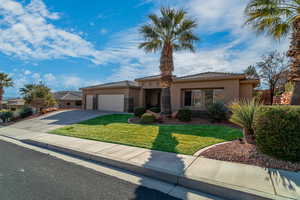 View of front of property featuring a garage and a front yard