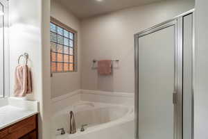 Bathroom with vanity and a bath