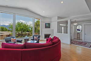 Living room featuring lofted ceiling and light hardwood / wood-style floors