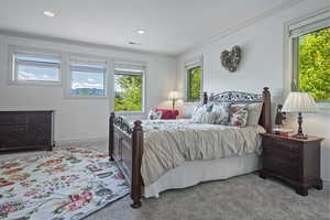 Bedroom featuring ornamental molding and light carpet