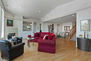 Living room featuring lofted ceiling and light hardwood / wood-style flooring