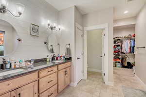 Bathroom with double vanity and water closet