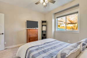 Bedroom with ceiling fan and carpet floors