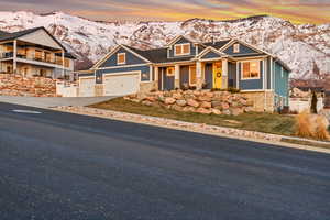 Craftsman inspired home featuring a mountain view and a garage