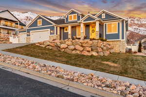 Craftsman house featuring a garage, a yard, and a mountain view