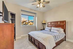 Bedroom with light colored carpet and ceiling fan