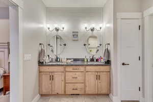 Bathroom featuring vanity and tile floors