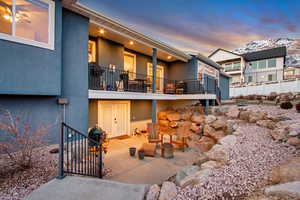 Patio terrace at dusk with a balcony and a mountain view