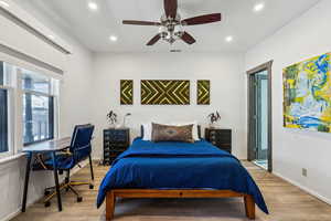 Bedroom with light hardwood / wood-style flooring and ceiling fan